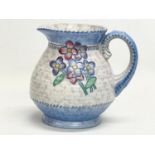 A 1930’s Charlotte Rhead pottery jug. Designed for Crown Ducal. 18x16cm