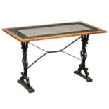 A cast iron garden table with slate top. 116.5x61x70.5cm.