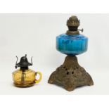 A Victorian oil lamp with Bristol Blue bowl and an Amber Glass finger lamp. 31cm