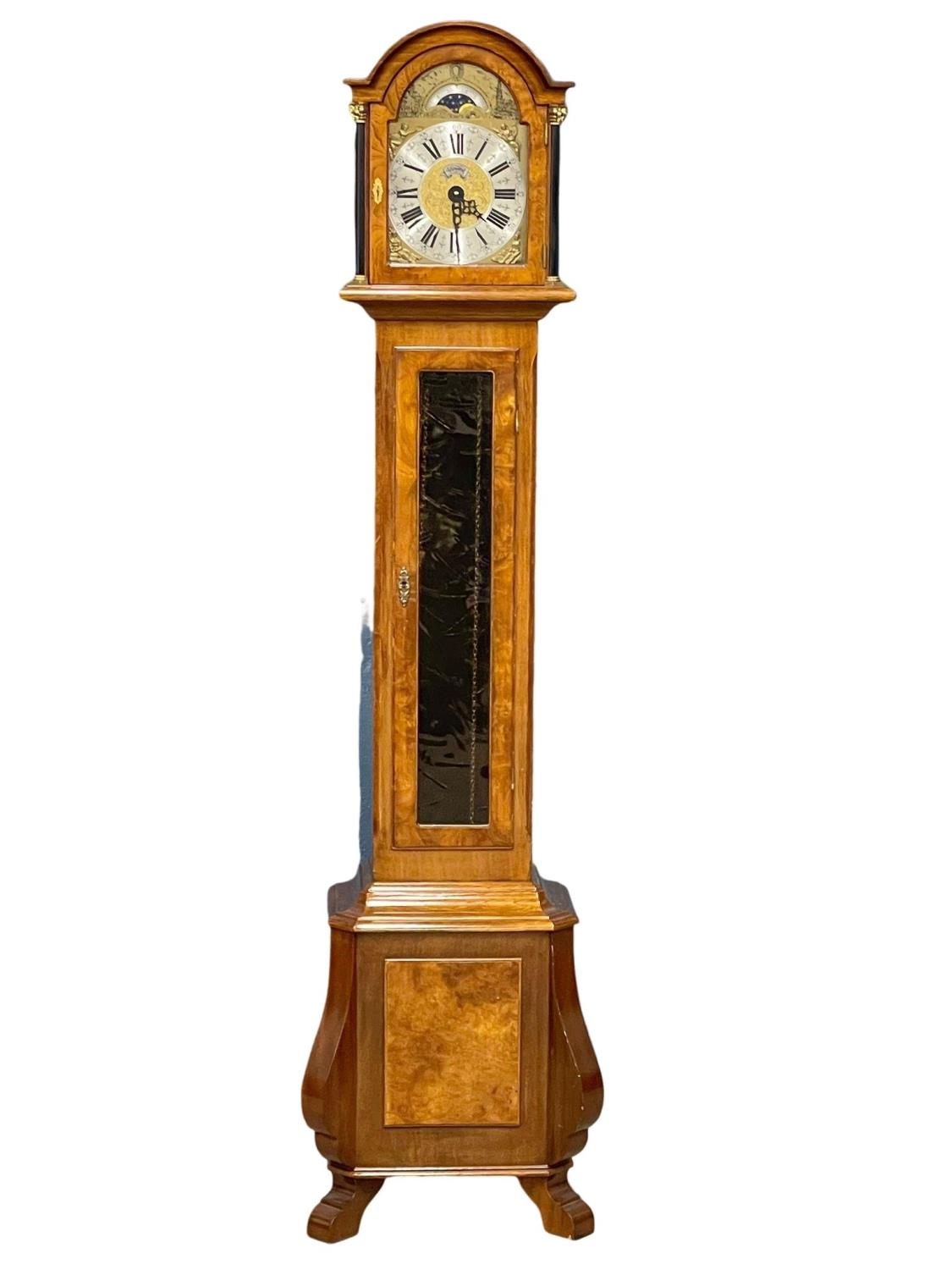A mahogany and burr walnut long case clock with brass moon dial face. By Warmink. Weights and