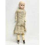 A large late 19th/early 20th century doll with plaster face and arms. 59cm