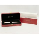 A Cartier ballpoint pen in case and box.