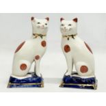 A pair of Staffordshire Ware pottery cats. 18.5cm