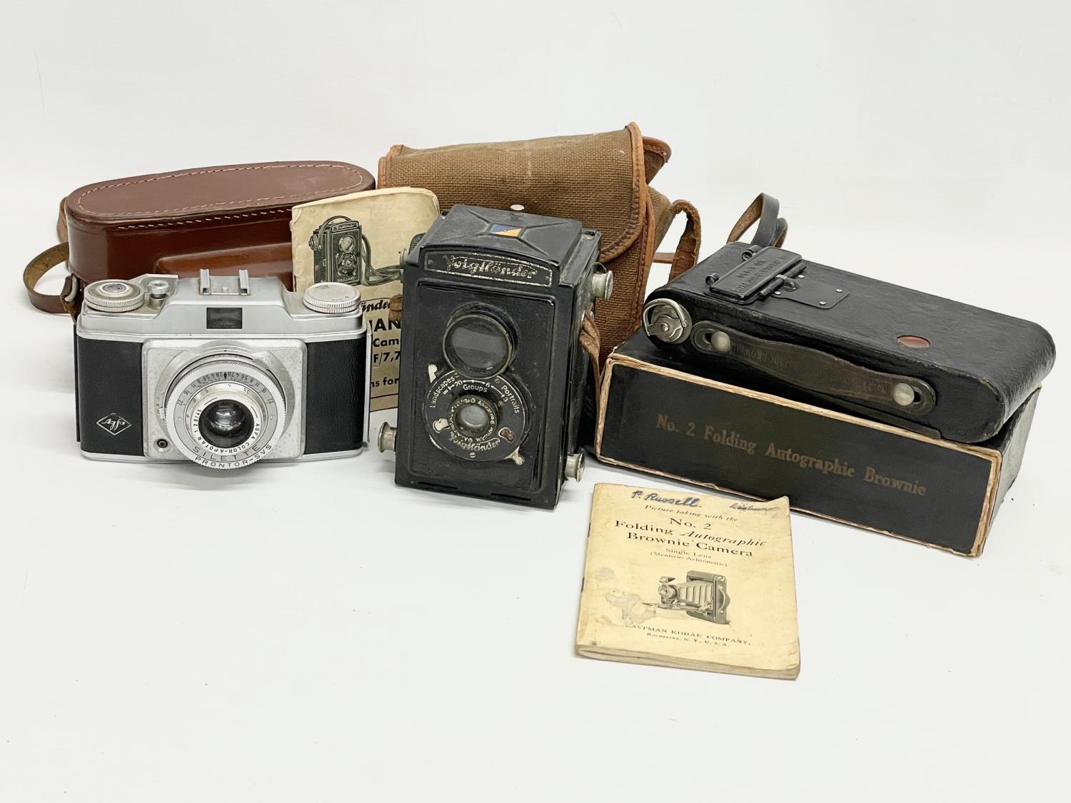 3 vintage cameras.