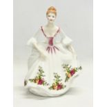 A Royal Doulton ‘Country Rose’ pottery figurine. 21cm.