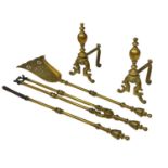 A set of early 20th century brass fire andirons and tools.