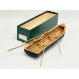 An Irish hand made Currach model in box. Made in Connemara. Boat measures 31cm.