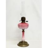 A tall Victorian ornate pottery and brass double burner oil lamp. 67cm