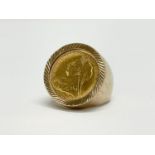 A 9ct gold Victorian half sovereign ring. 1898. 11.25 grams total.