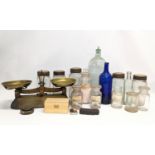 A sundry lot of 19th / 20th century glass bottles and jars, with a set of brass Avery scales.