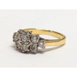 An 18ct gold ring with 8 inset diamonds. 3.83g. Size UK J.