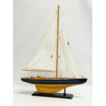 A wooden model yacht. 42x55.5cm
