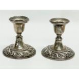 A pair of sterling silver candlesticks. 7x7.5cm