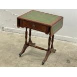 A small mahogany drop leaf end table with leather top and drawer.