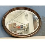 An early 20th century oval bevelled mirror. 85x60cm