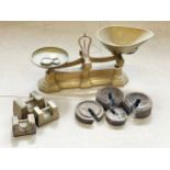 A brass H. Pooley & Son LTD scales and weights.