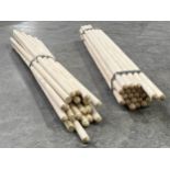 A quantity of wooden brush shafts. 120cm