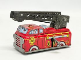 A vintage tinplate windup Yone fire engine. Made in Japan. 10cm closed.