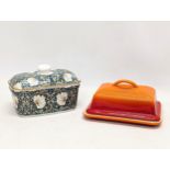 A Le Creuset butter dish and a William Morris pottery butter dish from The Leonardo Collection.