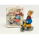 A vintage Kovap tinplate windup Boy on Tricycle in original box.