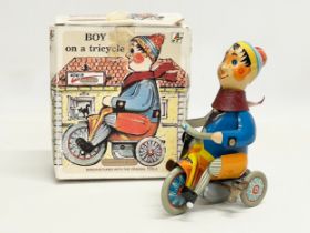 A vintage Kovap tinplate windup Boy on Tricycle in original box.