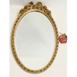 A vintage ornate gilt framed bevelled mirror. 37x62cm