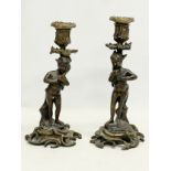 A pair of 19th century French bronze cherub candlesticks. 23cm