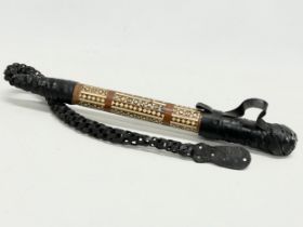 A vintage inlaid camel whip with hidden stiletto knife. 83cm total.