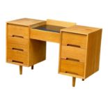 A Mid Century oak ‘C Range’ desk designed by John & Sylvia Reid for Stag. 1960. 121.5x45.5x77cm