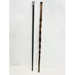 2 late 19th/early 20th century walking sticks. 1 with silver top.