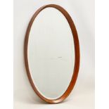 A G-Plan Mid Century teak framed oval mirror. 43x71cm