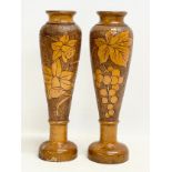 A pair of large late 19th century wooden candleholders with Pokerwork decoration. Circa 1890-1900.