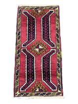 A vintage Middle Eastern hand knotted rug. 49x105cm