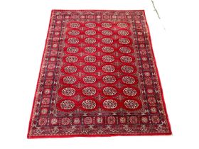 A vintage Middle Eastern style rug. 240x169cm