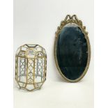 A brass and bevelled glass light shade and an ornate brass framed mirror. Shade measures 18x25cm