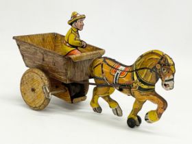 A vintage Marx tin plate windup horse and cart. 24cm