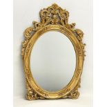 An ornate gilt framed mirror. 37x54cm