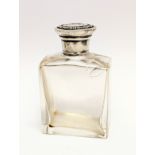 A glass scent bottle with silver top. 8.5cm