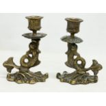 A pair of late 19th/early 20th century brass candlesticks. 10x14cm