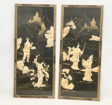 A pair of early 20th century Japanese hand painted lacquered wall plaques with faux ivory motif