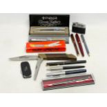 A collection of pens and knives. Parker, Sheaffer, Dromona. Cougar Lumberjack knife in box.