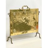 An early 20th century brass fire screen. 69x19x64cm