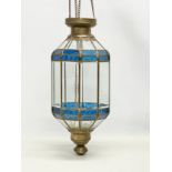 A large early 20th century brass and stain glass pendant candleholder. 24x78cm