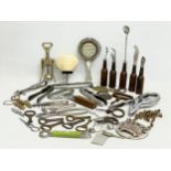 A collection of vintage cork screws and bottles openers etc.