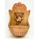 An ornate terracotta garden wall font. 37x61cm