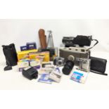 A collection of vintage cameras and equipment, including a Polaroid Land Camera Model 800, a Carl