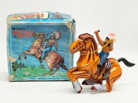 A vintage tinplate windup Indian on Horse in original box. Made in Korea. Box measures 16x15cm
