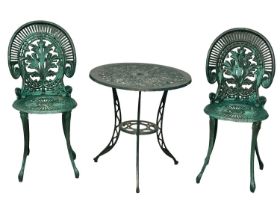 A Victorian style cast alloy garden table with 2 chairs. 60x62cm