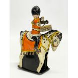 A vintage tinplate windup British Drummer on horse. Made in Great Britain. 15cm