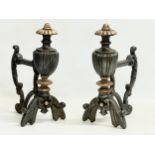 A pair of late 19th century cast iron fire andirons. 19x30cm